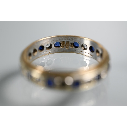 218 - A 9ct yellow and white gold eternity ring set alternate blue sapphires and white stones, size O, app... 