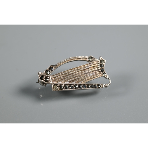 219 - An Irish silver and marcasite brooch in the form of a harp, an Art Deco marcasite brooch, a part dre... 