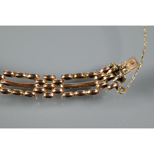 223 - A rose gold gatelink bracelet with concealed clasp and safety chain attached, stamped 15, approx 12.... 