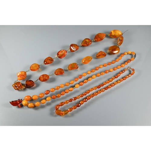 263 - Three rows of amber - one of oval graduated 'butterscotch' beads, 27.5g, one oval faceted graduated ... 