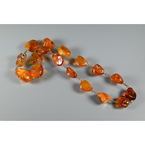 263 - Three rows of amber - one of oval graduated 'butterscotch' beads, 27.5g, one oval faceted graduated ... 