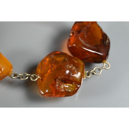 263 - Three rows of amber - one of oval graduated 'butterscotch' beads, 27.5g, one oval faceted graduated ... 