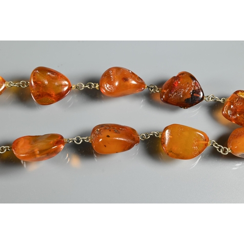 263 - Three rows of amber - one of oval graduated 'butterscotch' beads, 27.5g, one oval faceted graduated ... 