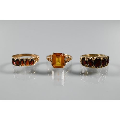 268 - Three rings - a rectangular step cut citrine in 9ct yellow gold shank with decorative plume shoulder... 