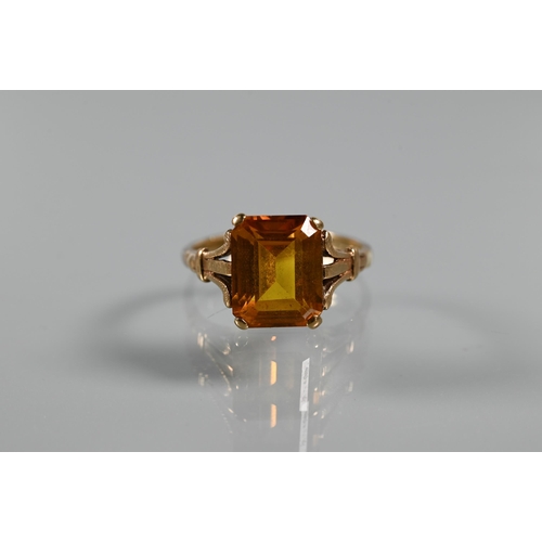 268 - Three rings - a rectangular step cut citrine in 9ct yellow gold shank with decorative plume shoulder... 