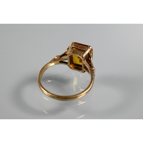 268 - Three rings - a rectangular step cut citrine in 9ct yellow gold shank with decorative plume shoulder... 