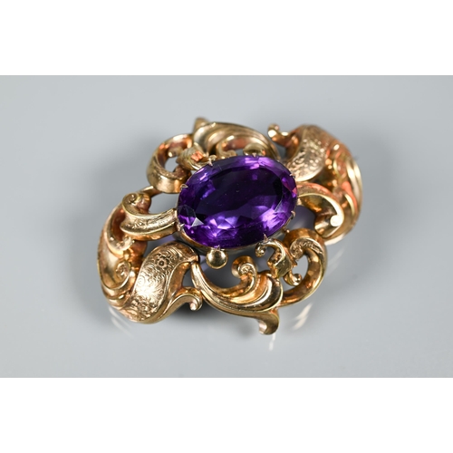 271 - A large Victorian brooch with large purple stone in ornate gilt metal scroll mount, 7 x 6 cm to/w a ... 