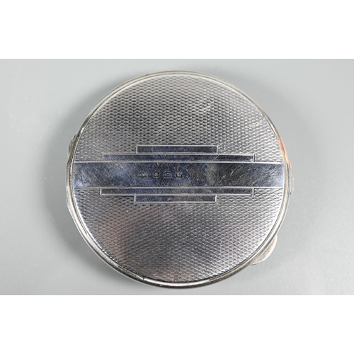 275 - An Art Deco silver compact with engine-turned decoration, Birmingham 1921, 6.5 cm diam to/w green oc... 