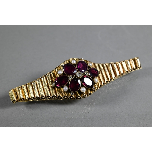 280A - A Victorian garnet, diamond and pearl yellow gold elliptical bracelet formed of foliate engraved tub... 