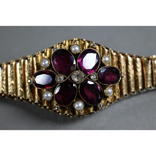 280A - A Victorian garnet, diamond and pearl yellow gold elliptical bracelet formed of foliate engraved tub... 