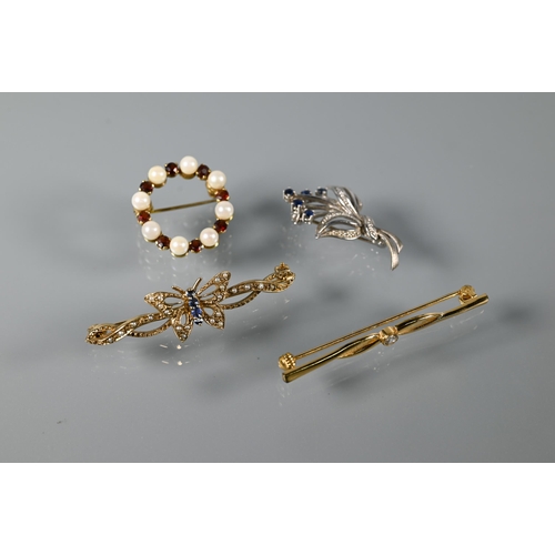 291 - Three various 9ct brooches - a white gold floral spray set with sapphires, a bar brooch in the form ... 