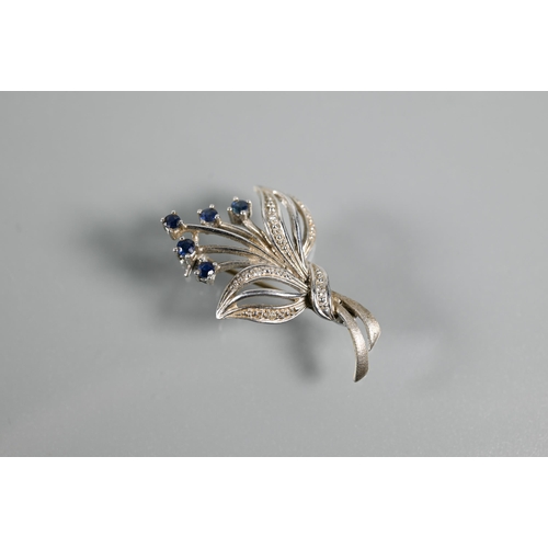 291 - Three various 9ct brooches - a white gold floral spray set with sapphires, a bar brooch in the form ... 