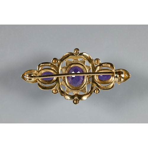 292 - A Victorian-style 9ct yellow gold brooch set with three oval amethysts in Gothic setting, 4 cm long,... 