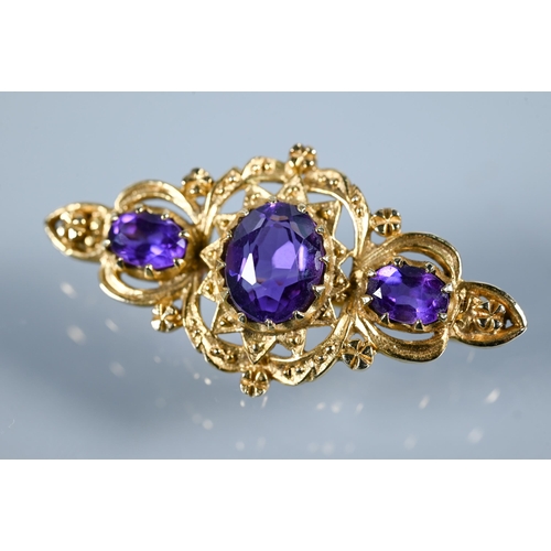 292 - A Victorian-style 9ct yellow gold brooch set with three oval amethysts in Gothic setting, 4 cm long,... 