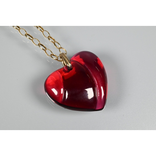 294 - A Baccarat red glass heart-shaped pendant, etched Baccarat, 3.5 cm long, on 9ct yellow gold belcher ... 