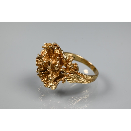 295 - A 1970s 9ct yellow gold ring in the form of a sculptural open flower, with textured shoulders, maker... 