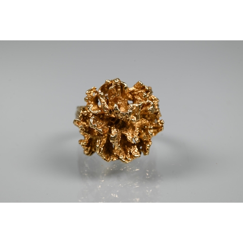 295 - A 1970s 9ct yellow gold ring in the form of a sculptural open flower, with textured shoulders, maker... 