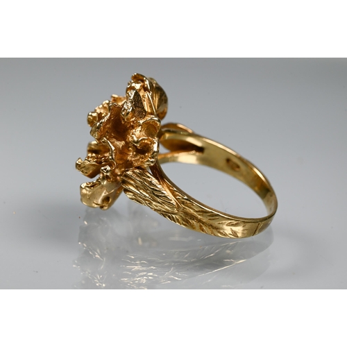 295 - A 1970s 9ct yellow gold ring in the form of a sculptural open flower, with textured shoulders, maker... 