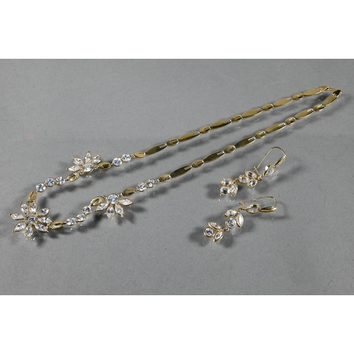 300A - A necklace and earring suite  formed of flat links with flower style clusters set possibly white spi... 