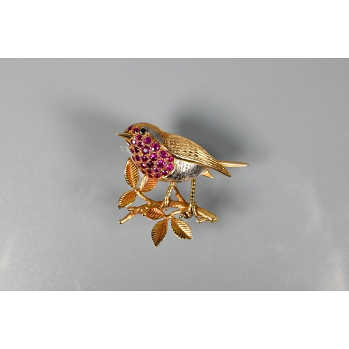 301 - A gold and ruby brooch in the form of a robin perched on a branch, with vari-textured body and ruby ... 
