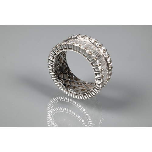 304 - A contemporary diamond cluster eternity ring, the centre with a row of rectangular baguette-cut diam... 