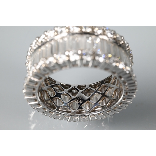 304 - A contemporary diamond cluster eternity ring, the centre with a row of rectangular baguette-cut diam... 