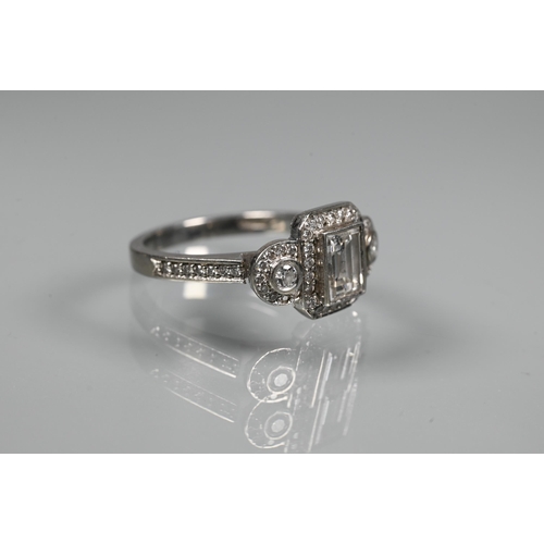 305 - An Art Deco style diamond-set cluster ring, the central rectangular diamond flanked by a collet set ... 