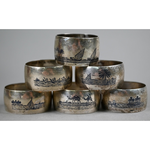 31 - Six Egyptian white metal napkin rings decorated with niello Nile scenes, to/w a Franklin Mint gold o... 