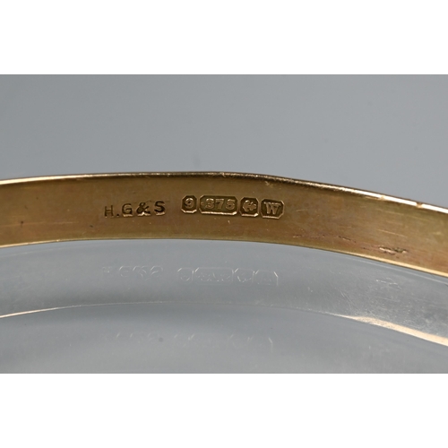 312 - A 9ct yellow gold expanding Christening bangle with engine turned decoration, size 6cm diam (max), a... 