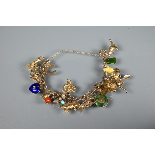 313 - A 9ct yellow gold curb bracelet with twenty various charms attached including kangaroo, pig, cat, en... 