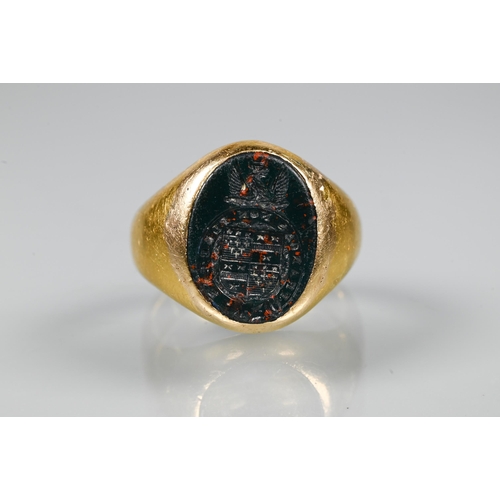 316 - A yellow metal signet ring inset with bloodstone intaglio, unmarked, approx 11g all in, size I