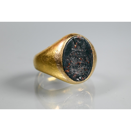 316 - A yellow metal signet ring inset with bloodstone intaglio, unmarked, approx 11g all in, size I