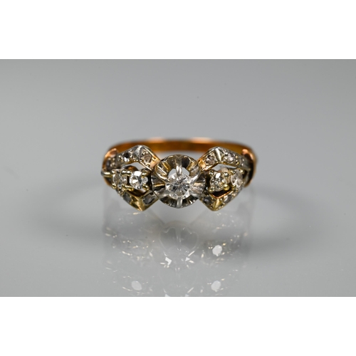 317 - A diamond cluster ring, the claw set diamonds in the form of a stylised bow, yellow metal set (unmar... 