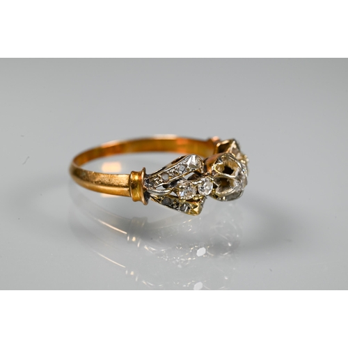 317 - A diamond cluster ring, the claw set diamonds in the form of a stylised bow, yellow metal set (unmar... 