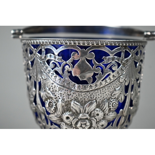 50 - A George III silver sugar basin with gadrooned swing handle, the body pierced, embossed and chased w... 