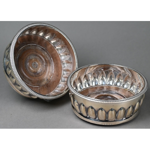52 - A heavy quality pair of George III silver bottle coasters with gadrooned rims and lancet reeding, tu... 