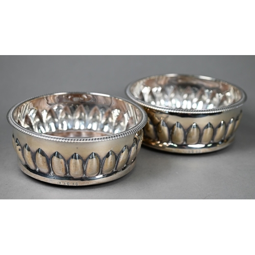 52 - A heavy quality pair of George III silver bottle coasters with gadrooned rims and lancet reeding, tu... 