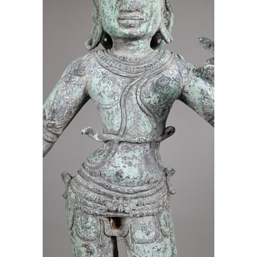 565 - A large Indian bronze figure of the Hindu deity Shiva standing on a stepped lotus base in the Chola ... 