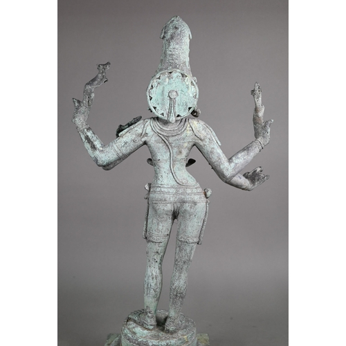 565 - A large Indian bronze figure of the Hindu deity Shiva standing on a stepped lotus base in the Chola ... 