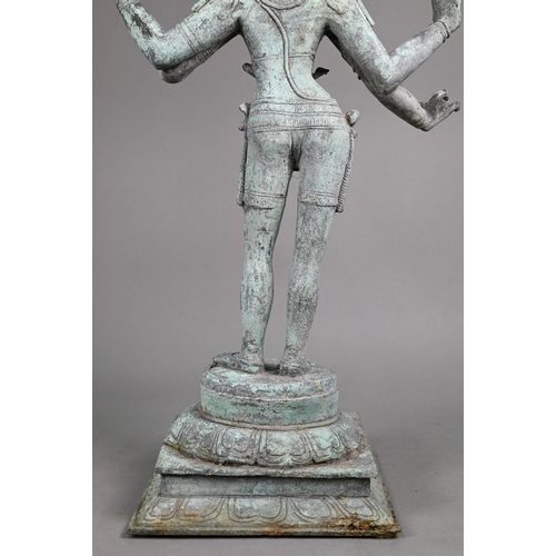 565 - A large Indian bronze figure of the Hindu deity Shiva standing on a stepped lotus base in the Chola ... 