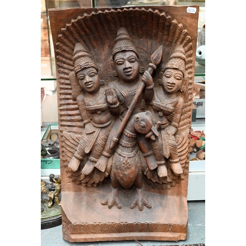 566 - An Indian high-relief carved hardwood panel depicting Karkikeya (Hindu God of War) and his two conso... 