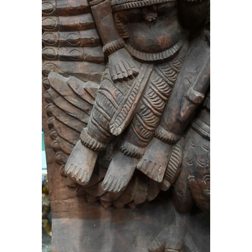 566 - An Indian high-relief carved hardwood panel depicting Karkikeya (Hindu God of War) and his two conso... 