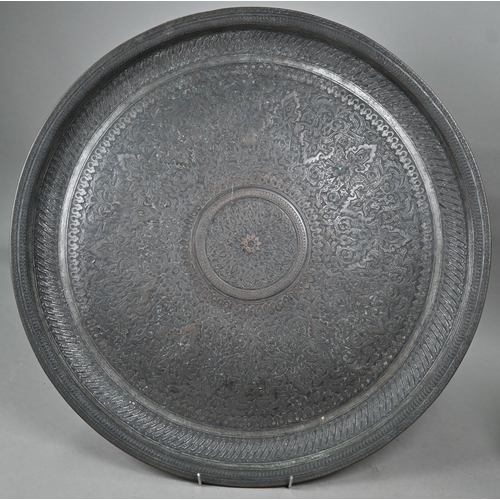 568 - A large Middle-Eastern engraved and embossed copper charger, 52 cm diameter, four various 19th centu... 