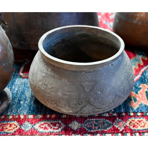 569 - A collection of antique Persian Qajar Islamic tinned copper metal ware including a large slender pit... 