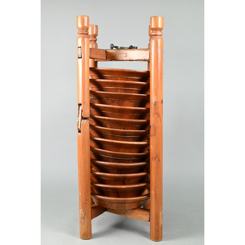 579 - A set of twelve traditional Chinese pine plates stacked in a caddy rack carrier, 20th century, 54 cm... 