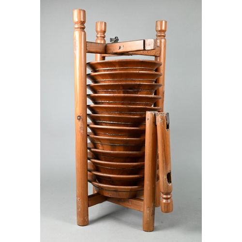 579 - A set of twelve traditional Chinese pine plates stacked in a caddy rack carrier, 20th century, 54 cm... 