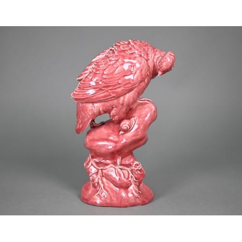 596 - A Minton pink majolica partridge perched on a rock, inspecting a snail, 33 cm high (c 1900)