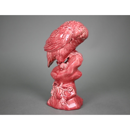 596 - A Minton pink majolica partridge perched on a rock, inspecting a snail, 33 cm high (c 1900)