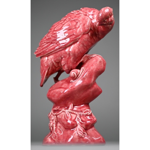 596 - A Minton pink majolica partridge perched on a rock, inspecting a snail, 33 cm high (c 1900)