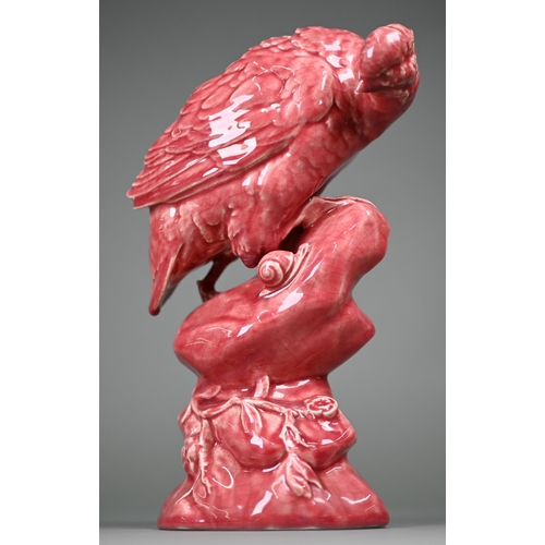 596 - A Minton pink majolica partridge perched on a rock, inspecting a snail, 33 cm high (c 1900)